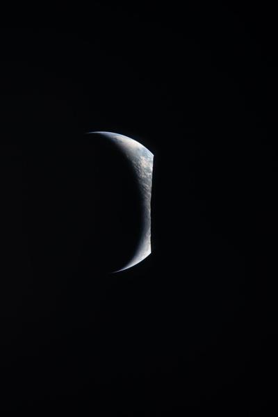 Thin crescent Earth from lunar orbit